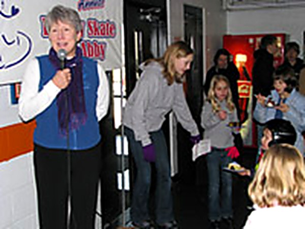Foundation representative speaking at a Family Skate for Abby grant presentation